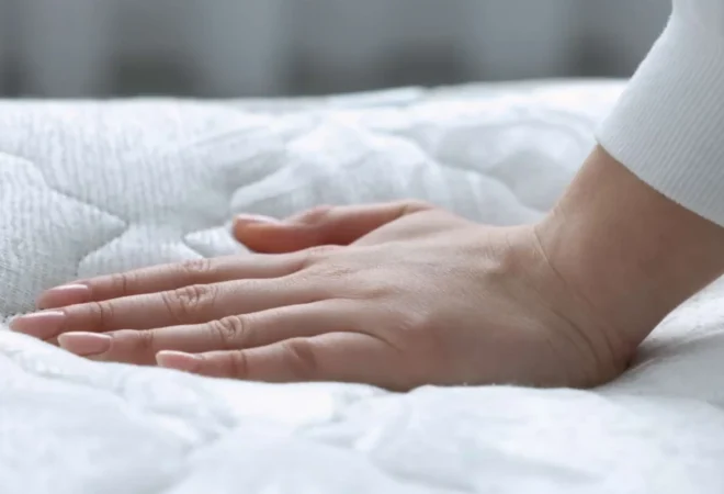 Hand pressing into plush mattress